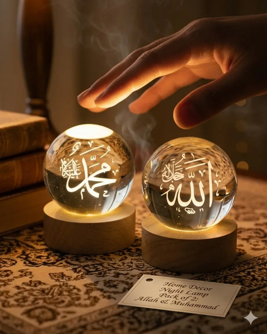 Two crystal night lights with engraved text on wooden bases, one being touched by a hand.